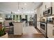Open kitchen featuring granite counters, stainless steel appliances, and island seating at 128 Madison Bnd, Woodstock, GA 30188