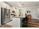 Modern kitchen with stainless steel appliances, an island with seating, and pendant lighting at 128 Madison Bnd, Woodstock, GA 30188