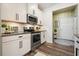 Contemporary kitchen featuring stainless steel appliances and white cabinetry at 128 Madison Bnd, Woodstock, GA 30188