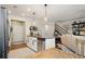 Open-concept kitchen with granite countertops, white cabinets, and stainless-steel appliances at 128 Madison Bnd, Woodstock, GA 30188