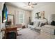 Living room area with a comfortable couch, desk area, and neutral color scheme at 128 Madison Bnd, Woodstock, GA 30188