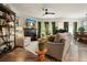 Open-concept living area featuring a fireplace, piano, and stylish furnishings at 128 Madison Bnd, Woodstock, GA 30188