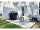 A covered grill, table, and chairs make this patio area the perfect space for outdoor dining at 128 Madison Bnd, Woodstock, GA 30188