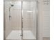 Modern shower with clear glass enclosure and a tiled wall, offering a clean and bright space at 128 Madison Bnd, Woodstock, GA 30188