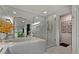 Bathroom featuring separate glass shower, soaking tub, and large mirror at 2660 Peachtree Rd # 6A, Atlanta, GA 30305