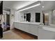 Bathroom featuring white vanity with double sinks, tile flooring, and large mirrors at 2660 Peachtree Rd # 6A, Atlanta, GA 30305