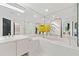 Bright bathroom featuring a dual vanity, soaking tub, and large mirrors, providing an open and luxurious feel at 2660 Peachtree Rd # 6A, Atlanta, GA 30305