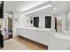 Bright bathroom features a double sink vanity, ample lighting, and a seamless connection to the bedroom at 2660 Peachtree Rd # 6A, Atlanta, GA 30305