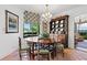 This charming dining area features terracotta floors, a crystal chandelier, and a view into the living room at 2660 Peachtree Rd # 6A, Atlanta, GA 30305
