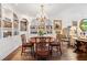 Elegant dining room with a round table, chandelier, and built-in bookshelves at 2660 Peachtree Rd # 6A, Atlanta, GA 30305