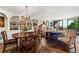 Open dining area with elegant table, chandelier, and views to the living space at 2660 Peachtree Rd # 6A, Atlanta, GA 30305
