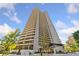Striking view of high-rise condo building with wrap-around balconies and lush landscaping at 2660 Peachtree Rd # 6A, Atlanta, GA 30305
