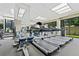 Modern gym featuring treadmills and various machines, with large windows offering natural light and green outdoor views at 2660 Peachtree Rd # 6A, Atlanta, GA 30305