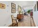 Well-lit hallway with hardwood floors, antique furniture, and a view to the living room at 2660 Peachtree Rd # 6A, Atlanta, GA 30305