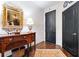 Elegant hallway featuring hardwood floors, classic artwork, and stylish doors at 2660 Peachtree Rd # 6A, Atlanta, GA 30305
