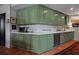 Galley kitchen featuring olive green cabinetry, stainless appliances, and terra cotta tile flooring at 2660 Peachtree Rd # 6A, Atlanta, GA 30305