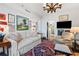 Cozy living room features an antique chandelier, fine art, a decorative rug, and comfortable seating at 2660 Peachtree Rd # 6A, Atlanta, GA 30305
