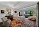 Spacious main bedroom with exposed beam ceilings, large window, and bright, patterned area rug at 2660 Peachtree Rd # 6A, Atlanta, GA 30305