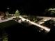 An outdoor patio area with manicured greenery is illuminated at night, offering an inviting place to relax and enjoy the outdoors at 2660 Peachtree Rd # 6A, Atlanta, GA 30305