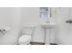 Features a toilet and a pedestal sink with a large mirror, offering a simple and functional design at 3848 Hester St, Duluth, GA 30097
