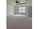 Spacious bedroom with carpet flooring, a ceiling fan, and a bright window providing plenty of natural light at 3848 Hester St, Duluth, GA 30097