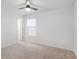 Features a ceiling fan, a window, and a door with carpeted floors for comfortable living at 3848 Hester St, Duluth, GA 30097