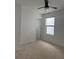 Bedroom featuring a ceiling fan, a door, and a window offering natural light at 3848 Hester St, Duluth, GA 30097
