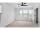 The bedroom boasts three windows, a ceiling fan and carpeted floors at 3848 Hester St, Duluth, GA 30097