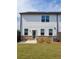 Exterior of home with stone elevation, AC Unit, and a small patio area at 3848 Hester St, Duluth, GA 30097
