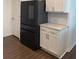 Close up of modern refrigerator and white cabinets with granite countertops at 3848 Hester St, Duluth, GA 30097
