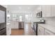Modern kitchen with stainless steel appliances, white cabinets, and a large center island at 3848 Hester St, Duluth, GA 30097