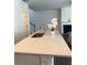 Bright kitchen island featuring a stainless steel sink, faucet, and quartz countertop, providing a modern and functional workspace at 3848 Hester St, Duluth, GA 30097