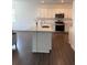Modern kitchen with white cabinets, stainless steel appliances, and center island at 3848 Hester St, Duluth, GA 30097