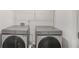 The laundry room has side-by-side Samsung washer and dryer in a well lit room at 3848 Hester St, Duluth, GA 30097