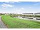 Scenic view of community pond reflecting nearby townhouses and landscaped surroundings at 3848 Hester St, Duluth, GA 30097