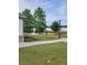 View of neighborhood pond featuring mature trees, a walking path, and community homes at 3848 Hester St, Duluth, GA 30097