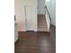 Hallway view featuring hardwood floors, an interior door, and a carpeted staircase leading to the second level at 3848 Hester St, Duluth, GA 30097
