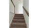 Carpeted stairs with white rails and a wooden handrail to the next level at 3848 Hester St, Duluth, GA 30097