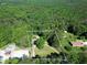 Aerial view of a property with a home, greenery, and boundaries outlined in white at 4289 Post Rd, Winston, GA 30187