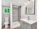 Modern bathroom featuring gray tiled shower, vinyl floor, updated vanity, and a window view at 4289 Post Rd, Winston, GA 30187