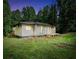 Exterior view of a home with a well-maintained yard and natural surroundings at 4289 Post Rd, Winston, GA 30187