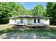 Charming single-story home featuring a front deck and surrounded by lush greenery at 4289 Post Rd, Winston, GA 30187