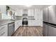 Bright kitchen with stainless steel appliances, granite countertops and white cabinets at 4289 Post Rd, Winston, GA 30187
