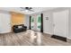 Spacious living area features hardwood floors, ample natural light and a stylish black sofa at 4289 Post Rd, Winston, GA 30187
