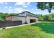 Backyard featuring well-maintained lawn, a dark fence, and views of the home's patio at 5370 Greenleaf Sw Dr, Mableton, GA 30126