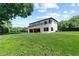 Large green backyard featuring well-maintained lawn, mature trees, and the home's deck at 5370 Greenleaf Sw Dr, Mableton, GA 30126