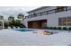 Luxurious backyard with a pool, sunken seating area, and elegant landscaping, creating a private oasis at 5370 Greenleaf Sw Dr, Mableton, GA 30126