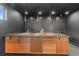 Modern home bar featuring wood slat accents, tile backsplash, pendant lighting and dark neutral decor at 5370 Greenleaf Sw Dr, Mableton, GA 30126