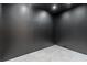 Minimalist finished basement area features dark wall paint and light gray tile flooring at 5370 Greenleaf Sw Dr, Mableton, GA 30126