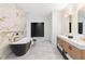 Elegant bathroom boasts a soaking tub, marble accents, and a stylish double vanity with ample storage at 5370 Greenleaf Sw Dr, Mableton, GA 30126